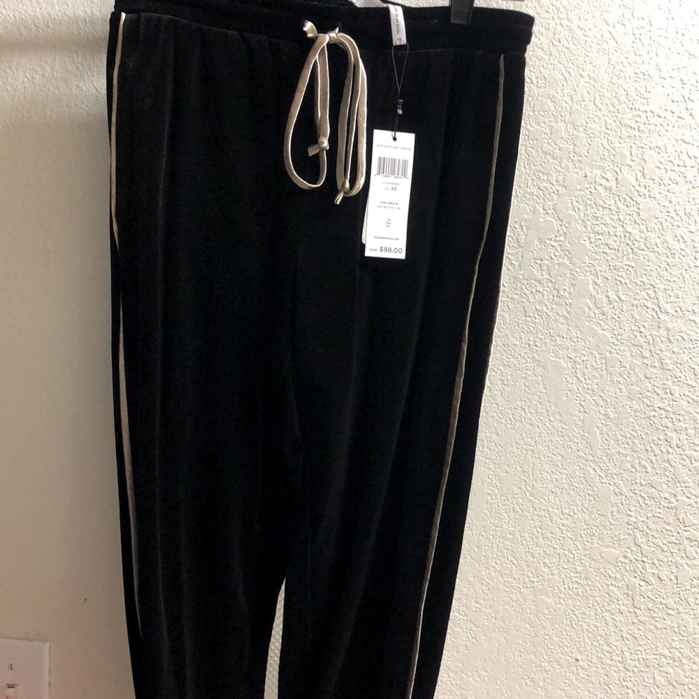 Bcbgeneration black velvet pants with gold trim.